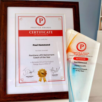 Paul Hammond holding the Retirement Coach of the Year 2026 award and certificate
