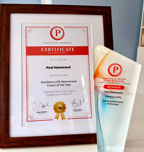 Paul Hammond holding the Retirement Coach of the Year 2026 award and certificate
