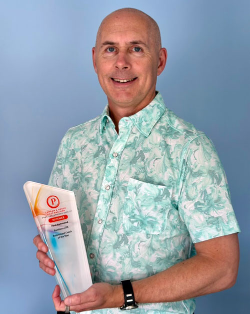 Paul Hammond holding the Retirement Coach of the Year 2026 award and certificate
